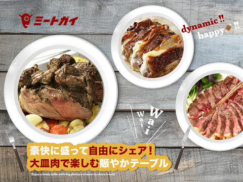 Serve generously and share freely! A lively table enjoying large meat platters 